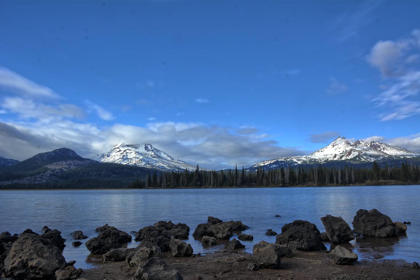 Snow-capped Cascade peaks above a lake in Central Oregon near Bend